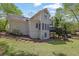 Spacious backyard featuring a patio and stairs, with natural landscaping and room for outdoor activities at 7037 Waters Edge Dr, Stone Mountain, GA 30087