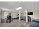 Basement with an open floor plan featuring laminate floors, a dining area, and entertainment area with fitness equipment at 7037 Waters Edge Dr, Stone Mountain, GA 30087