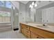 Bathroom with dual vanity, tile floors, and a step-in shower at 7037 Waters Edge Dr, Stone Mountain, GA 30087