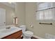 Cozy half bathroom features modern sink and vanity, plus a window with natural lighting at 7037 Waters Edge Dr, Stone Mountain, GA 30087