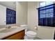 Bathroom features a wood vanity, toilet and patterned shower curtain at 7037 Waters Edge Dr, Stone Mountain, GA 30087