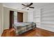 Bedroom features hardwood floors, ceiling fan, built-in shelving, and lots of natural light at 7037 Waters Edge Dr, Stone Mountain, GA 30087