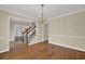 Dining area showcasing staircase, chandelier lighting, and access to living room with built-ins at 7037 Waters Edge Dr, Stone Mountain, GA 30087