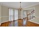 Dining room with hardwood floors, chandelier lighting, and access to staircase and entryway at 7037 Waters Edge Dr, Stone Mountain, GA 30087