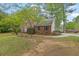 Traditional two-story home with brick facade and lush greenery, showcasing its charming curb appeal at 7037 Waters Edge Dr, Stone Mountain, GA 30087