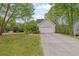 Exterior view of the home featuring a two-car garage and a long driveway at 7037 Waters Edge Dr, Stone Mountain, GA 30087