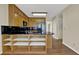 Kitchen featuring black countertops, stainless steel refrigerator, and plenty of cabinet storage at 7037 Waters Edge Dr, Stone Mountain, GA 30087