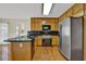 Modern kitchen with stainless steel appliances, black countertops, and light wood cabinetry at 7037 Waters Edge Dr, Stone Mountain, GA 30087