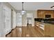 Eat-in kitchen boasts hardwood floors, modern lighting, granite countertops, and stainless steel appliances at 7037 Waters Edge Dr, Stone Mountain, GA 30087