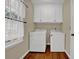 Laundry room features tile floors and a window for natural light at 7037 Waters Edge Dr, Stone Mountain, GA 30087