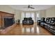 Comfortable living room with fireplace, ceiling fan, and hardwood floors, creating a relaxing atmosphere at 7037 Waters Edge Dr, Stone Mountain, GA 30087