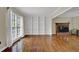 Bright living room with hardwood floors, a brick fireplace, and custom built-in bookshelves at 7037 Waters Edge Dr, Stone Mountain, GA 30087