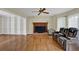 Inviting living room with hardwood floors, brick fireplace, built in shelves, and ample natural light at 7037 Waters Edge Dr, Stone Mountain, GA 30087