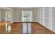 Open-concept living room with hardwood floors, built-in shelving, and plenty of natural light at 7037 Waters Edge Dr, Stone Mountain, GA 30087
