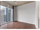 Bedroom featuring hardwood floors, large windows, city views, and light-colored walls at 855 Peachtree Ne St # 2403, Atlanta, GA 30308