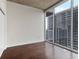 Bedroom with hardwood floors, a concrete ceiling, and a large window with city views at 855 Peachtree Ne St # 2403, Atlanta, GA 30308