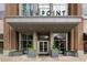 Grand building entrance with glass doors and planters, showcasing a welcoming arrival at 855 Peachtree Ne St # 2403, Atlanta, GA 30308
