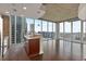 Modern kitchen with dark cabinets, granite countertops, and city views from large windows at 855 Peachtree Ne St # 2403, Atlanta, GA 30308