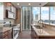 Modern kitchen with dark cabinets, stainless steel appliances and city view at 855 Peachtree Ne St # 2403, Atlanta, GA 30308