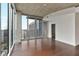 Bright living room featuring hardwood floors, modern windows, and city views at 855 Peachtree Ne St # 2403, Atlanta, GA 30308