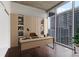 Modern office space with custom shelving, sleek desk, and city views at 855 Peachtree Ne St # 2403, Atlanta, GA 30308