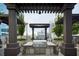 Outdoor grill area with a built-in grill, seating, and views of the city skyline at 855 Peachtree Ne St # 2403, Atlanta, GA 30308