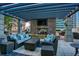 Cozy outdoor patio with a stone fireplace, comfortable seating, and a covered pergola at 855 Peachtree Ne St # 2403, Atlanta, GA 30308
