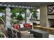 Stylish outdoor patio with comfortable seating, a fireplace, and views of the surrounding greenery at 855 Peachtree Ne St # 2403, Atlanta, GA 30308