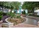 Lush rooftop garden with walkways, planters, and mature trees, offering a serene escape at 855 Peachtree Ne St # 2403, Atlanta, GA 30308