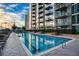Beautiful swimming pool with city views, surrounded by modern architecture and landscaping at 855 Peachtree Ne St # 2403, Atlanta, GA 30308