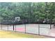 Outdoor basketball court with multiple hoops surrounded by mature trees at 3967 Bellingrath Main Nw, Kennesaw, GA 30144