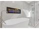 Elegant bathroom featuring a soaking tub, glass shower, and a modern fireplace at 3967 Bellingrath Main Nw, Kennesaw, GA 30144
