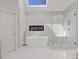 Luxurious bathroom with a freestanding tub, glass shower, and sleek modern design at 3967 Bellingrath Main Nw, Kennesaw, GA 30144