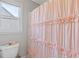 Cozy bathroom with pink ruffle shower curtain and window for natural light at 3967 Bellingrath Main Nw, Kennesaw, GA 30144