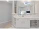 Bathroom vanity with white cabinets, a makeup vanity, and a large mirror at 3967 Bellingrath Main Nw, Kennesaw, GA 30144