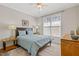 Comfortable bedroom featuring a ceiling fan, natural light, coordinated decor and hardwood floors at 3967 Bellingrath Main Nw, Kennesaw, GA 30144