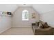 Cozy bonus room featuring a daybed, arched window, and neutral decor at 3967 Bellingrath Main Nw, Kennesaw, GA 30144
