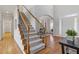 Grand foyer with hardwood floors, staircase with wood railing and iron spindles, and front door at 3967 Bellingrath Main Nw, Kennesaw, GA 30144