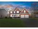Traditional brick home with a manicured lawn and a two-car garage at 3967 Bellingrath Main Nw, Kennesaw, GA 30144