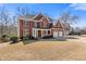 Brick home with black shutters has a well-manicured lawn and a two-car garage at 3967 Bellingrath Main Nw, Kennesaw, GA 30144