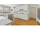 Spacious kitchen with white cabinets, granite countertops, stainless steel appliances and hardwood floors at 3967 Bellingrath Main Nw, Kennesaw, GA 30144