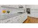 Modern kitchen with white cabinets, granite countertops, stainless steel appliances, and hardwood floors at 3967 Bellingrath Main Nw, Kennesaw, GA 30144