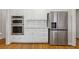 Bright kitchen featuring stainless steel appliances including built-in ovens and a large refrigerator at 3967 Bellingrath Main Nw, Kennesaw, GA 30144