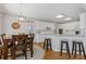 Eat-in kitchen area featuring granite countertops, white cabinets, a breakfast bar, and hardwood floors at 3967 Bellingrath Main Nw, Kennesaw, GA 30144