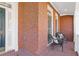 Cozy covered porch features brick flooring and comfortable seating at 3967 Bellingrath Main Nw, Kennesaw, GA 30144