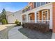 Inviting covered front porch features classic columns and meticulous landscaping at 3967 Bellingrath Main Nw, Kennesaw, GA 30144
