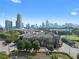 Stunning aerial view of the condominium complex with a backdrop of the city skyline and lush green surroundings at 400 17Th Nw St # 2218, Atlanta, GA 30363
