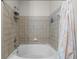 Clean bathroom featuring a white tub and tiled wall enclosure with shower at 400 17Th Nw St # 2218, Atlanta, GA 30363