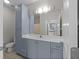 Bathroom featuring a vanity with ample storage and a large mirror with modern lighting and tile floors at 400 17Th Nw St # 2218, Atlanta, GA 30363