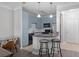 Well-lit kitchen with blue cabinetry, black appliances, and breakfast bar overlooking the living room at 400 17Th Nw St # 2218, Atlanta, GA 30363